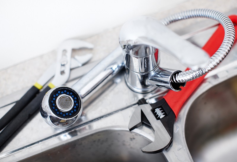 Kitchen sink. Adjustable wrench. Plumbing. Plumber tool